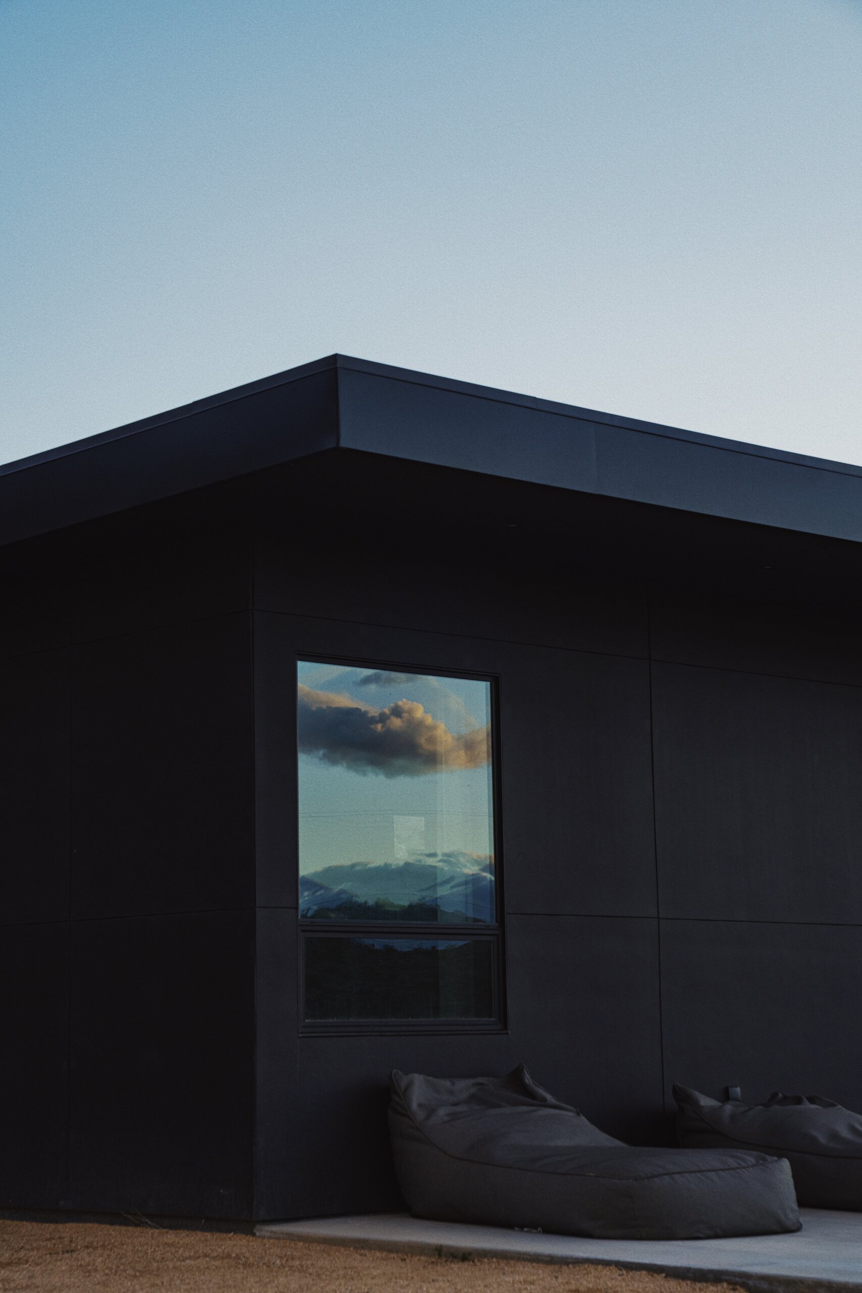 Dark facade and window pattern at Pause House PM