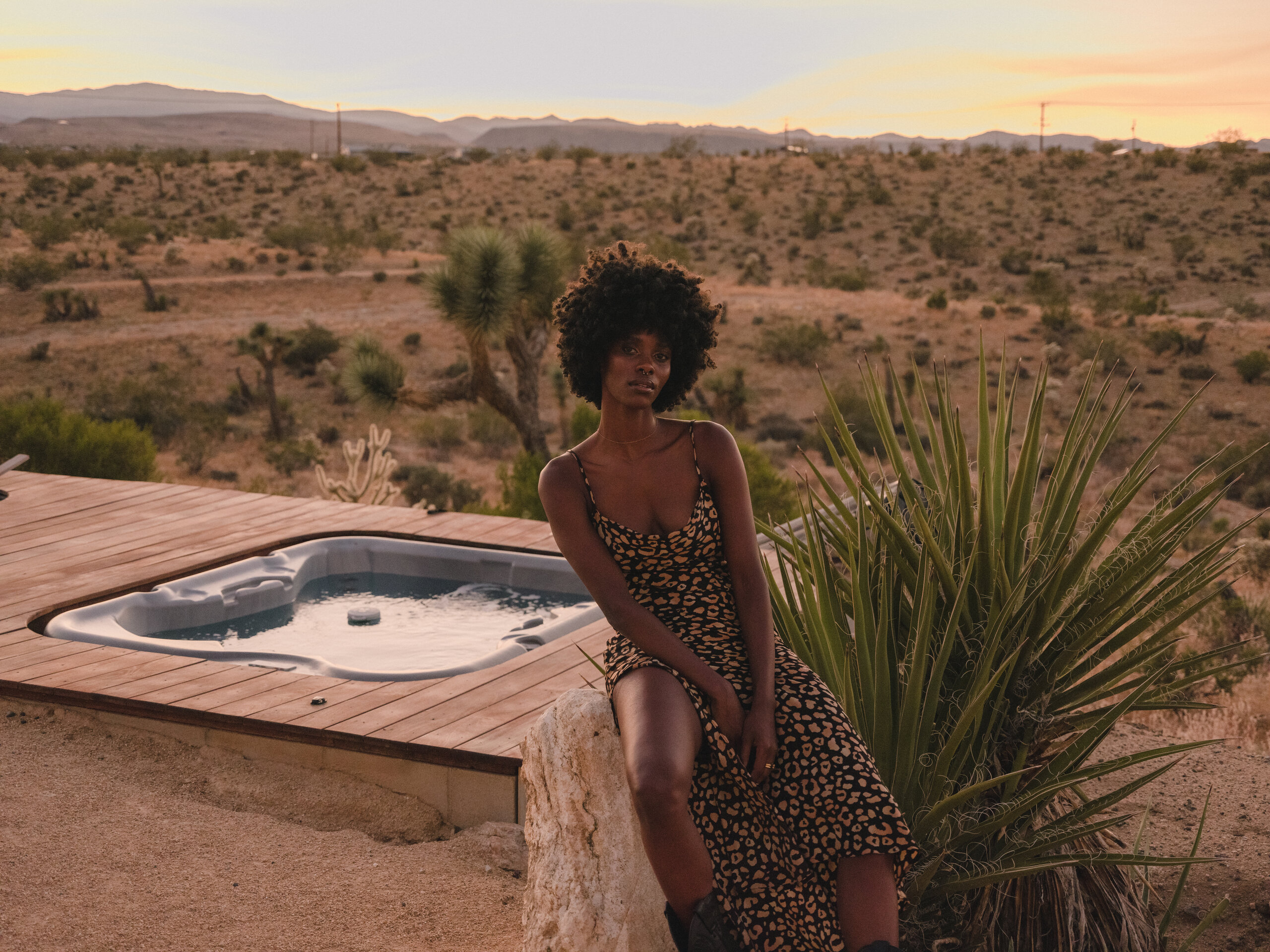 Guest at the Pause House AM hot tub in golden-hour light